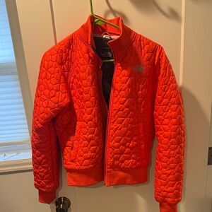 Orange North Face quilted jacket